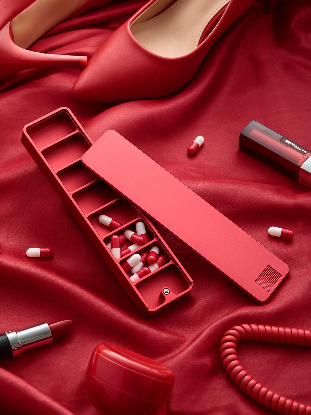 Red Ikigai weekly pill case open on red silk